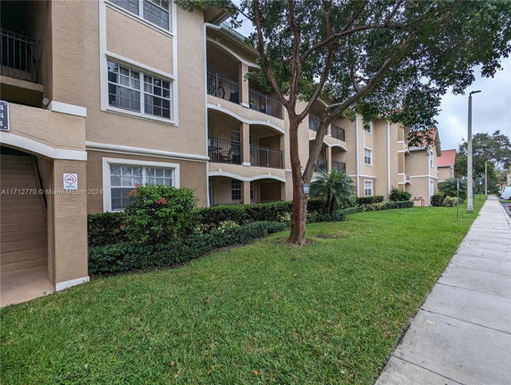 Front view of a multi-story apartment building with balconies.