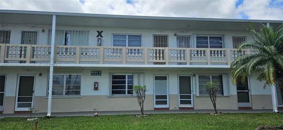 Front view of a two-story building with a balcony.