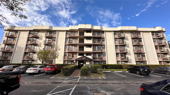 Front view of a multi-story residential building with balconies.