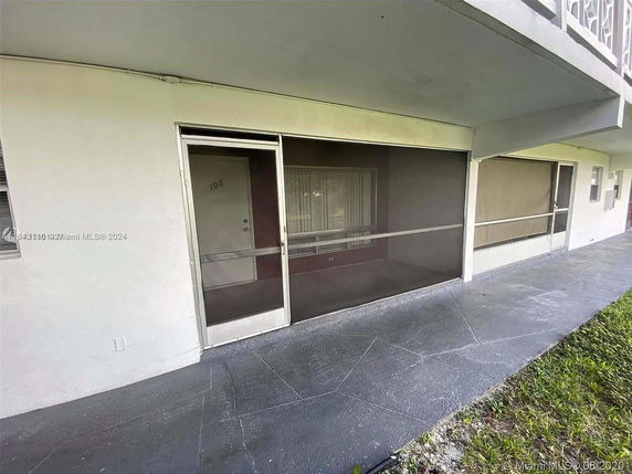 Front view of a residential building with a screened porch area.