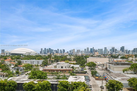 Panoramic view of a cityscape with skyline and buildings under a blue sky.