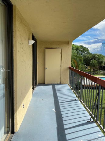 Balcony view with guardrail and surrounding landscape.