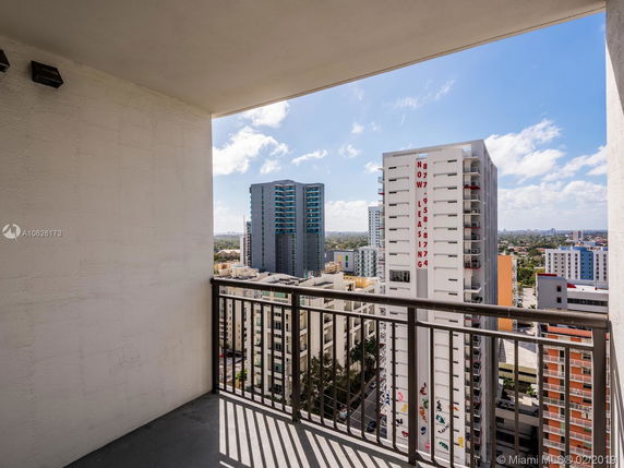 Panoramic view from a balcony showing surrounding high-rise buildings.