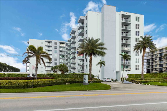 Front view of a multi-story apartment building with balconies.
