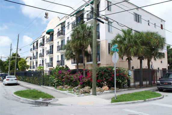 Front view of a multi-story residential building with balconies.