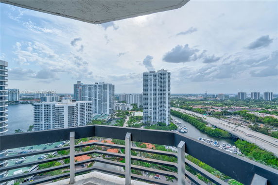 View from a building overlooking nearby waterfront and high-rise buildings.