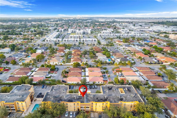 Aerial panoramic view of a residential neighborhood with various houses and apartment buildings.