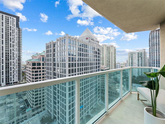 Panoramic view from a balcony showcasing high-rise buildings in an urban area.