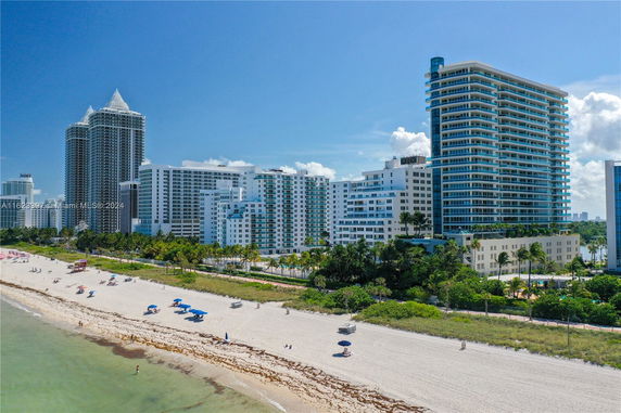 View of several high-rise buildings near a sandy beach.