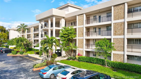 Front view of a multi-story apartment building with balconies.