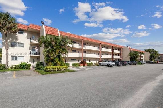 Front view of a multi-story residential building with balconies.