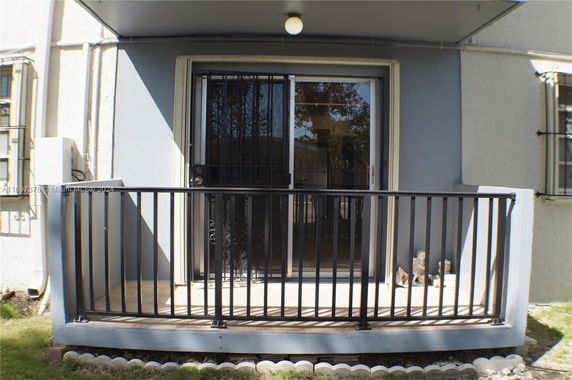 Front view of a house with a small balcony and railings.