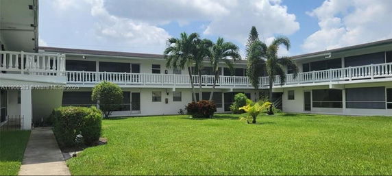 Front view of a two-story building with exterior walkways and balconies.