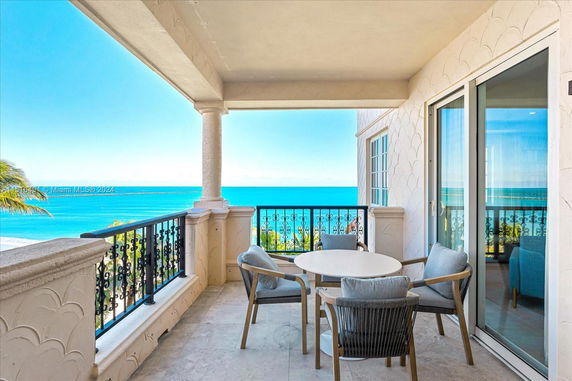 Outdoor patio with seating area overlooking the ocean.