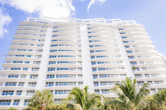 Front view of a multi-story modern building with curved balconies.