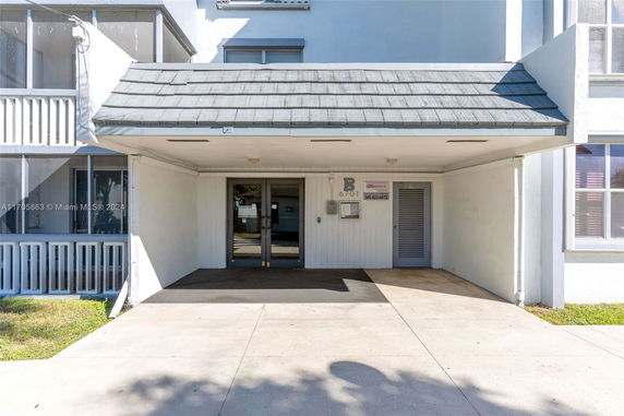 Front view of a building entrance with a covered walkway.