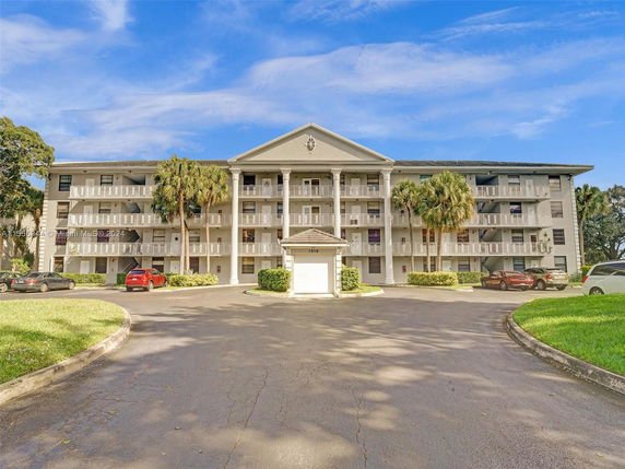 Front view of a multi-story residential building with balconies.