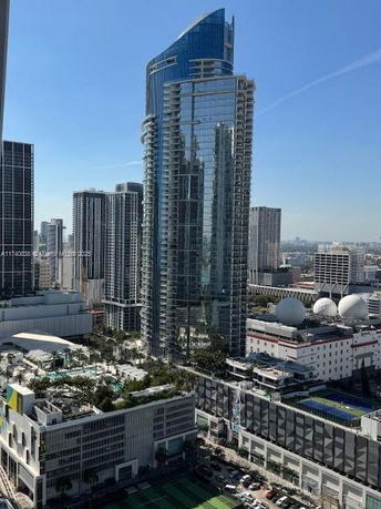 Panoramic view of a cityscape with tall skyscrapers and urban buildings.