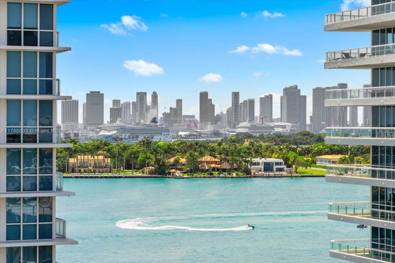Panoramic view of a city skyline with high-rise buildings and a bay area.