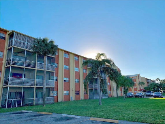 Front view of a multi-story apartment building with balconies.