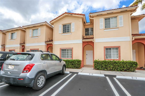 Front view of a two-story house with parking spaces.