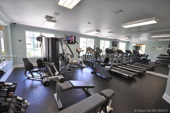 Indoor gym with various exercise equipment and treadmills.