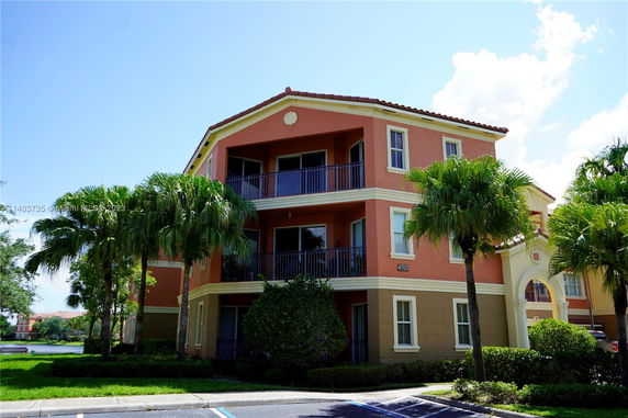 Front view of a multi-story residential building with balconies.