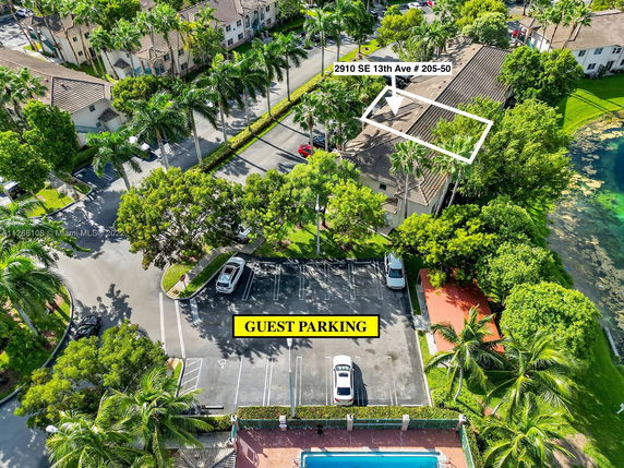 Aerial view of residential area with guest parking and nearby buildings.
