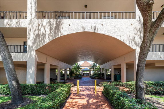 Front view of a building with a covered walkway and balconies.