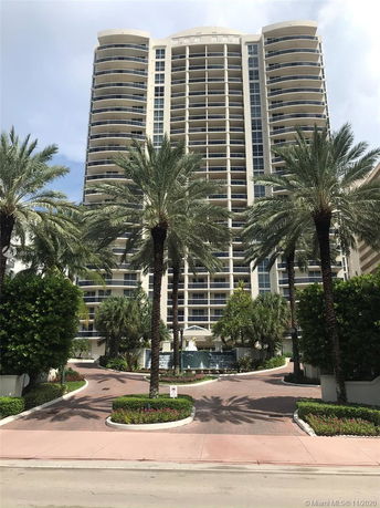 Front view of a tall multi-story building with balconies.