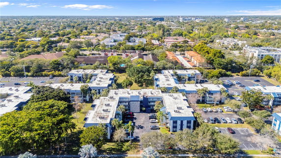 Aerial view of residential buildings and surrounding neighborhood.