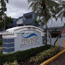 Front view of a building with a sign for 'The Beach Club'.