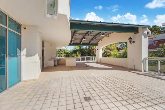Open rooftop area with a covered section and railing.