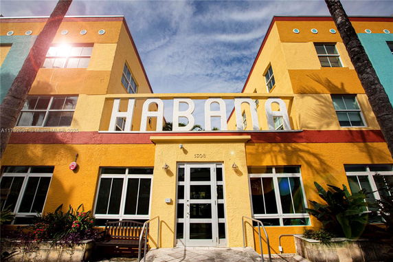 Front view of a building with colorful facade and large signage.