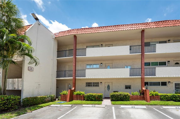 Front view of a multi-story residential building with balconies.
