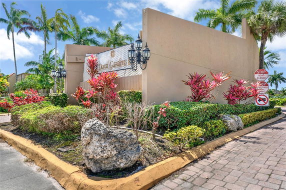 Outdoor view of an entrance area with landscaping and signage.