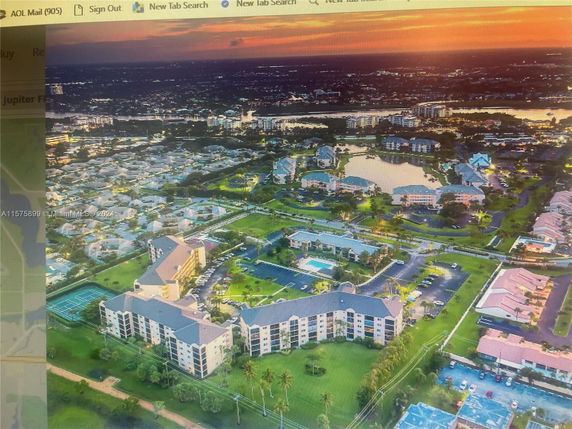 Panoramic view of residential buildings and surrounding landscape at sunset.