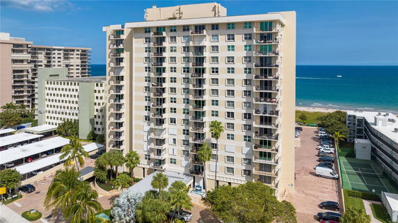 Front view of a multi-story beachfront building complex.