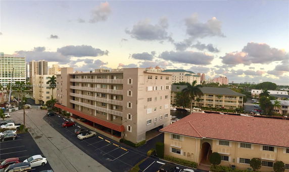 Panoramic view of a neighborhood with multistory buildings and rooftops.