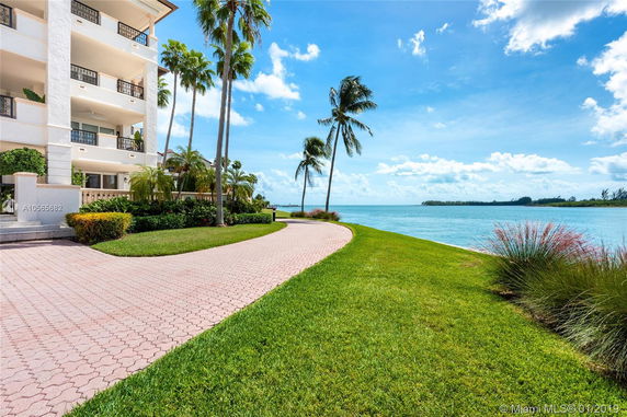 View of a waterfront building with multiple balconies.