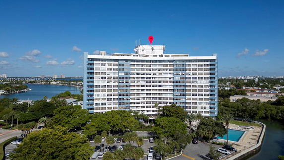 Front view of a large, multi-story residential building with many windows.