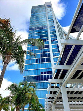 Front view of a modern glass high-rise building.