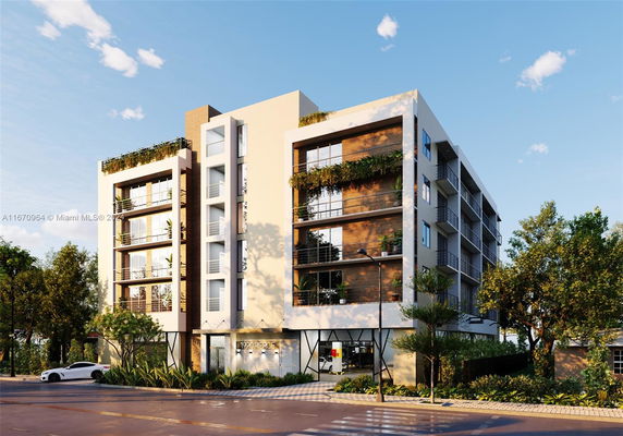 Front view of a multi-story building with modern design and balconies.