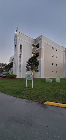 Front view of a multi-story residential building with balconies.