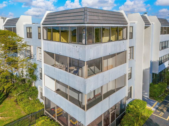 Front view of a multi-story residential building with balconies.