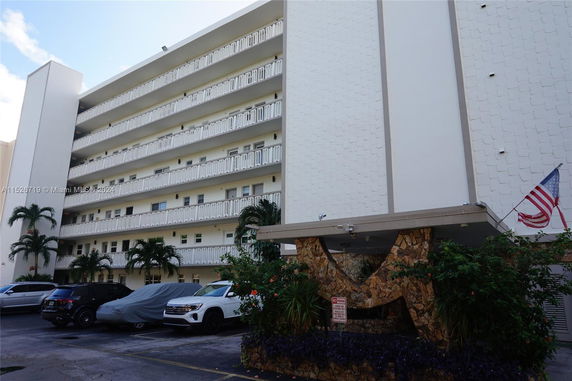 Front view of a multi-story building with balconies.