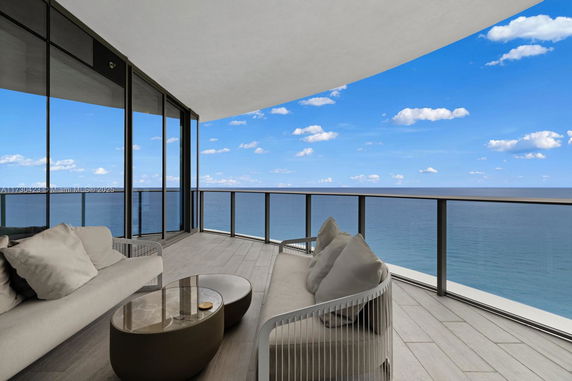 Panoramic view from a balcony overlooking the ocean.