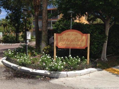 Front view of a condominium complex entrance with a sign reading Heritage Circle.