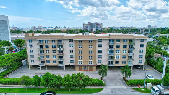 Front view of a multi-story residential building with multiple balconies.