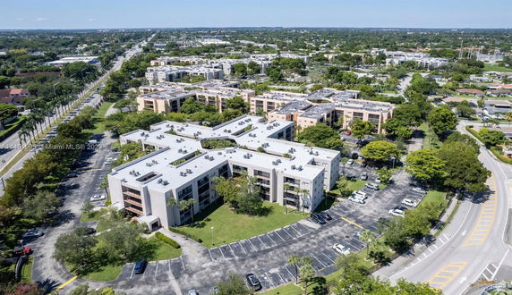 Aerial view of a residential complex with multiple buildings and surrounding roads.
